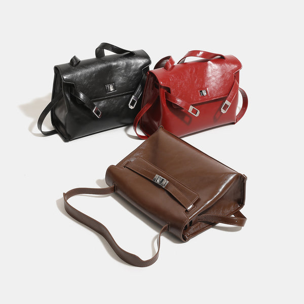 Structured rectangular flap shoulder bag in glossy leather-look finish with silver turn-lock clasp and adjustable strap