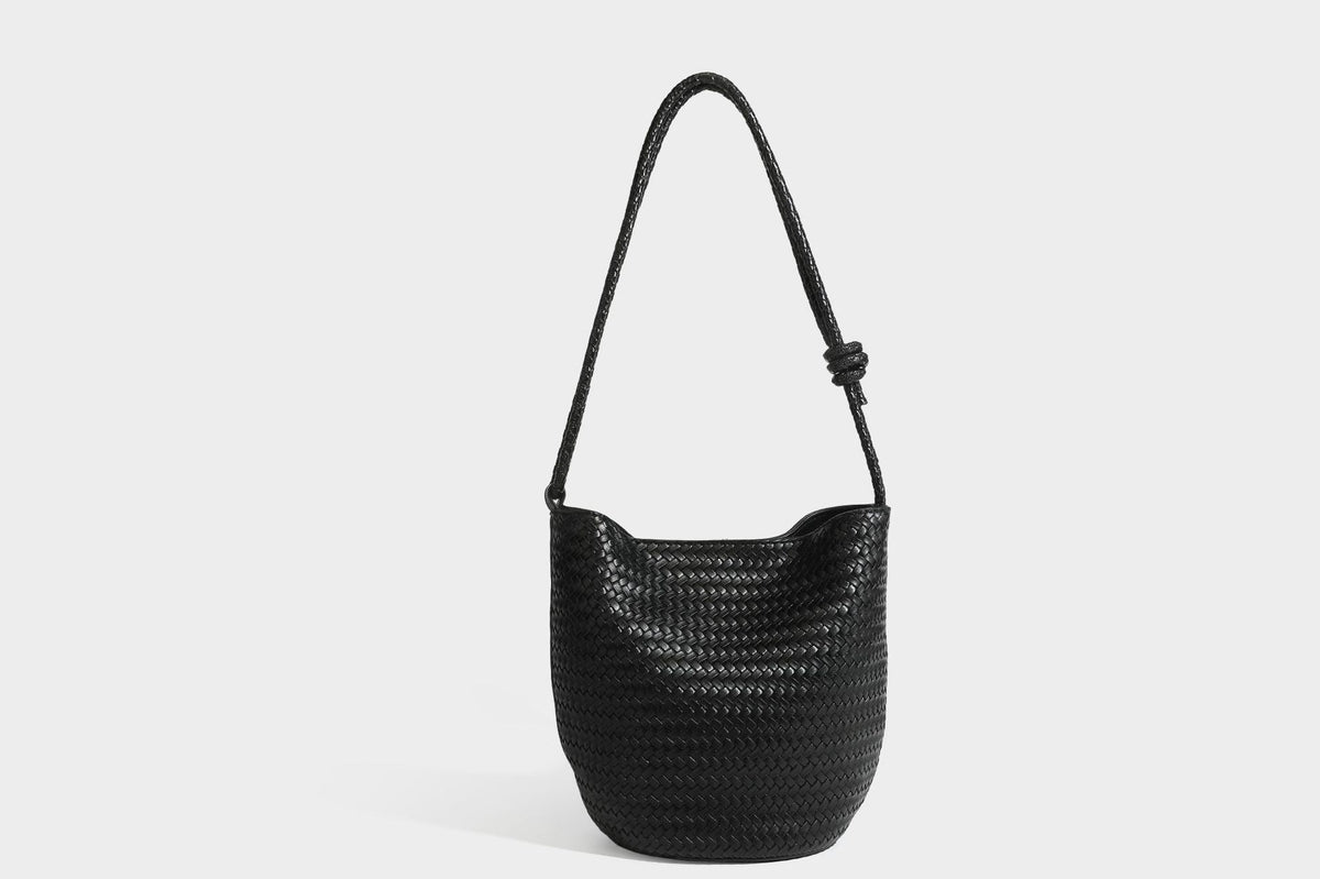 Olive green woven leather-look bucket bag with braided crossbody strap, knotted adjustment, and gold-tone tassel charm with