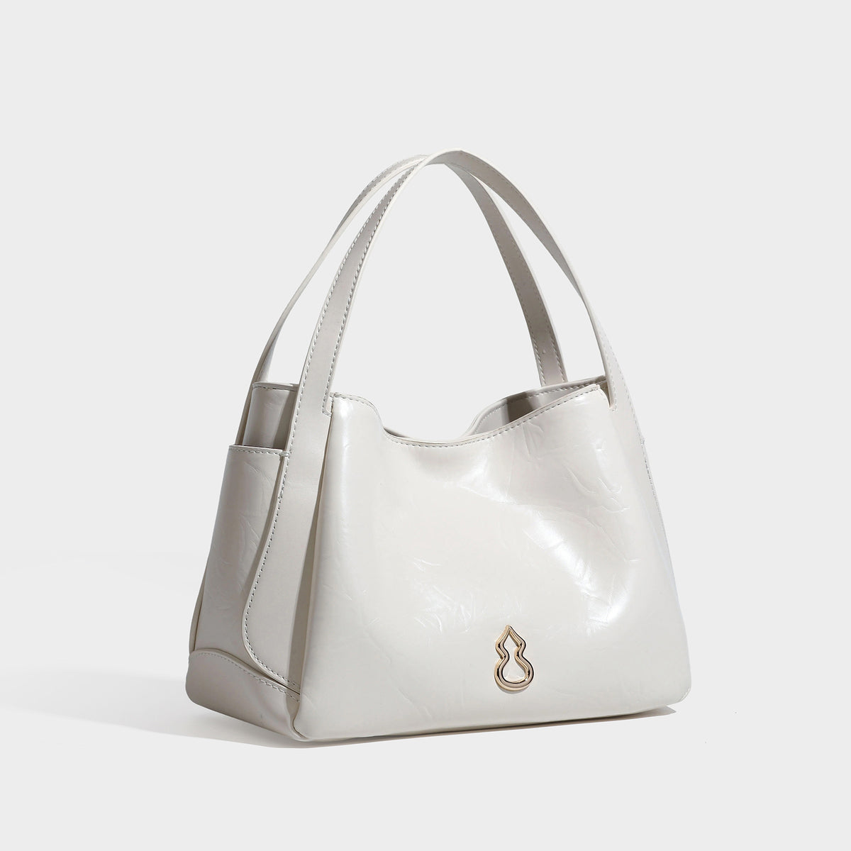 Black glossy crinkled leather-look convertible shoulder tote bag with gold gourd-shaped emblem hardware and detachable