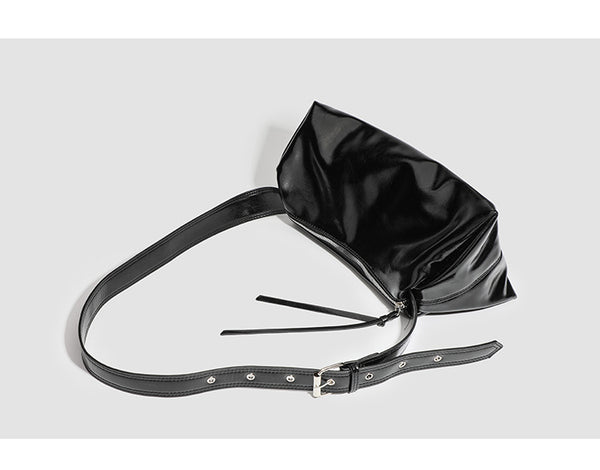 Black glossy leather-look slouchy shoulder bag with gathered top, zip tassel closure, and long adjustable silver-buckle