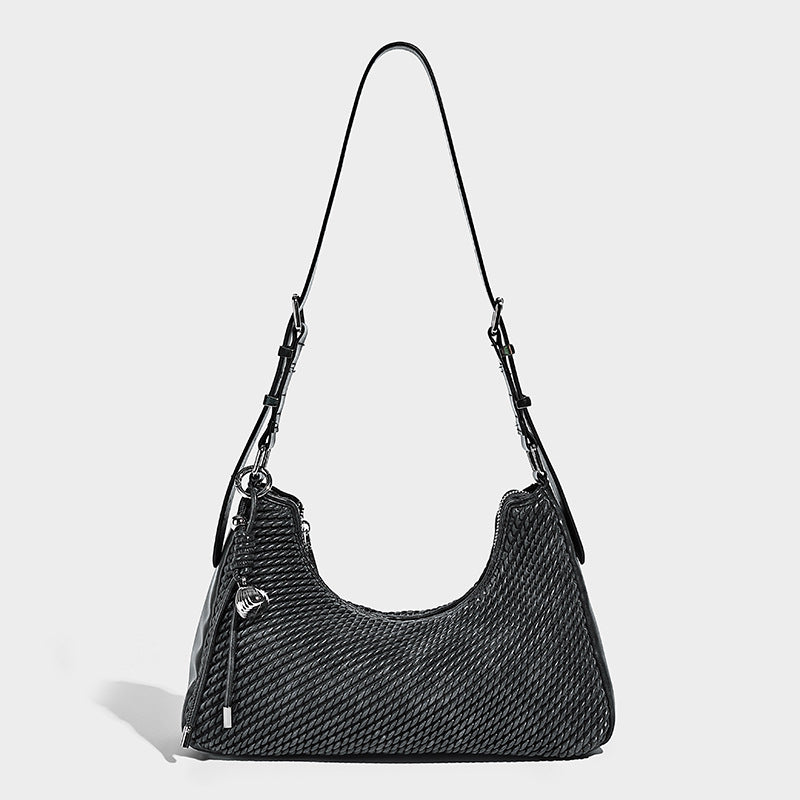 Woven crescent hobo shoulder bag with smooth side panels, zip-top closure, silver-tone charm hardware, and adjustable, detail