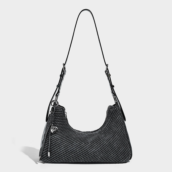 Woven crescent hobo shoulder bag with smooth side panels, zip-top closure, silver-tone charm hardware, and adjustable, detail