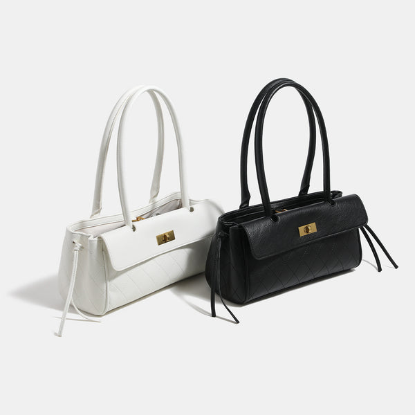 Structured quilted diamond-stitch baguette handbag with gold-tone turn-lock closure and dual top handles, detail view 2