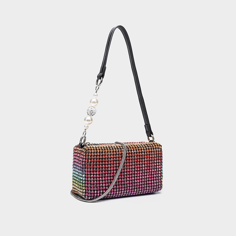 Small rectangular all-over rhinestone crossbody bag with pearl bead zipper pull and detachable silver chain strap, detail