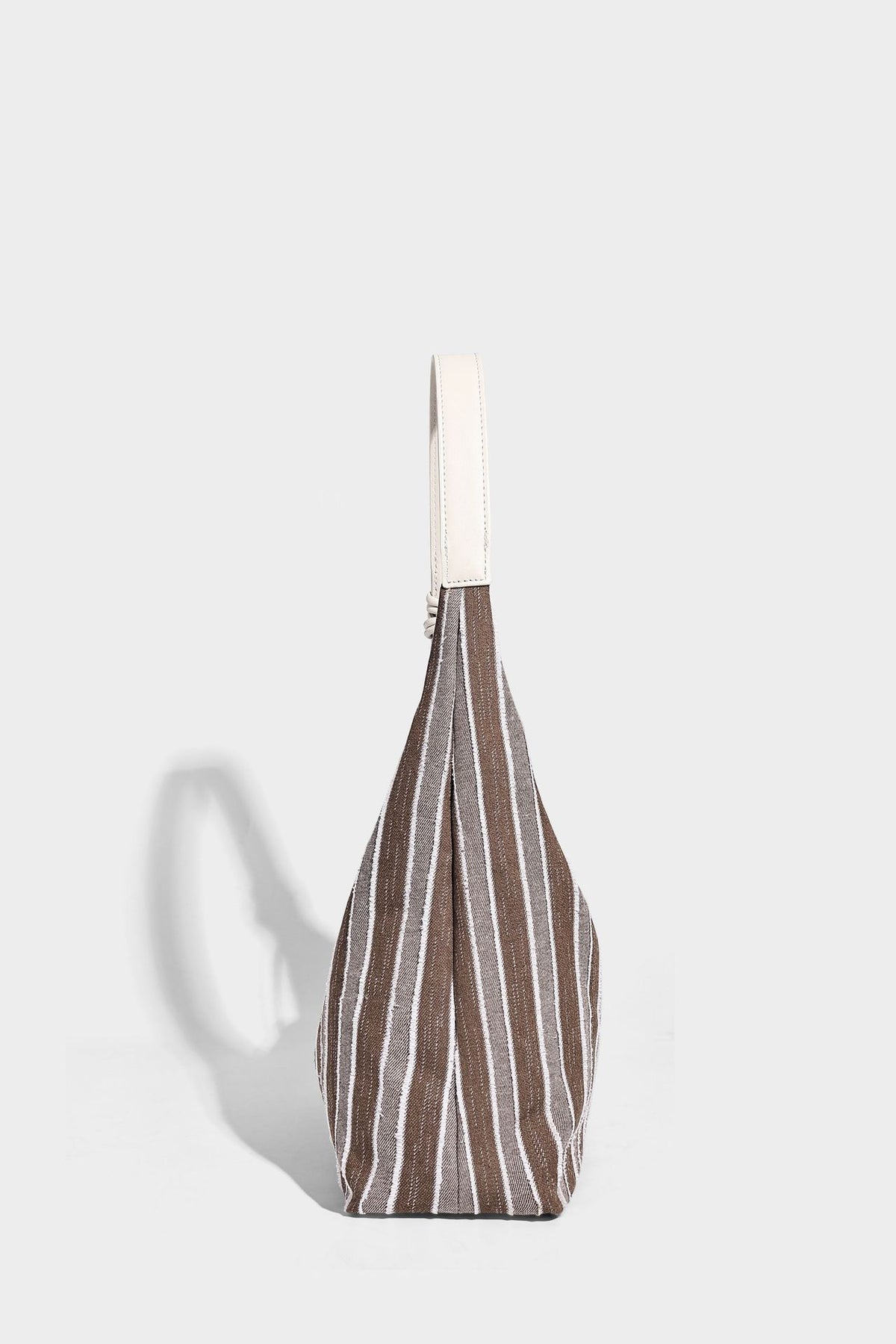 Slouchy striped canvas hobo shoulder bag with cream trim and long knotted strap, detail view 10
