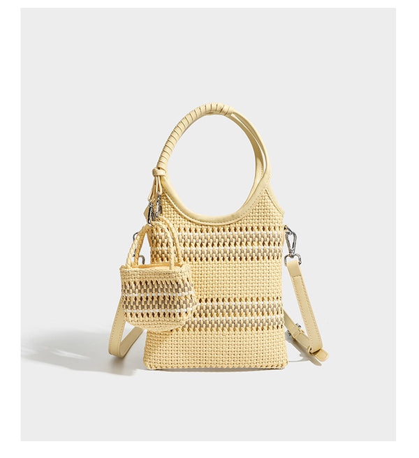 Brown two-tone woven leather-look shoulder bag with braided top handles, detachable mini pouch, and adjustable crossbody