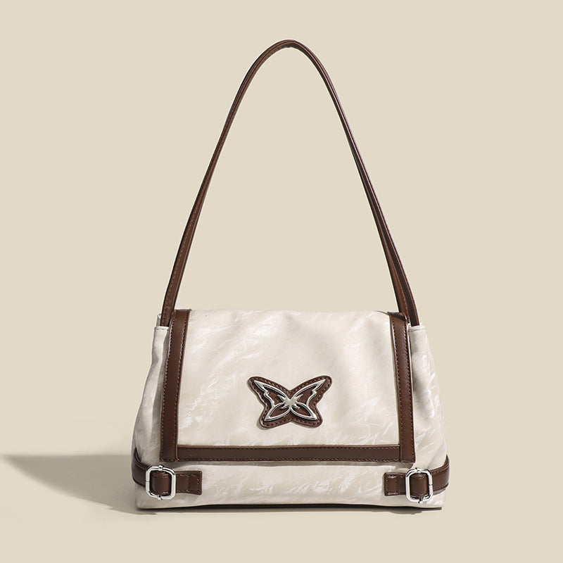 Structured crinkle-finish flap shoulder bag with butterfly metal appliqué and dark brown contrast trim, detail view 7