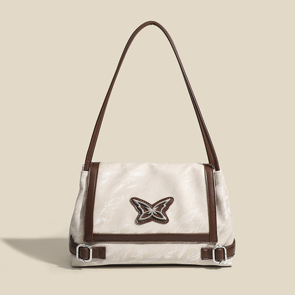 Structured crinkle-finish flap shoulder bag with butterfly metal appliqué and dark brown contrast trim, detail view 7