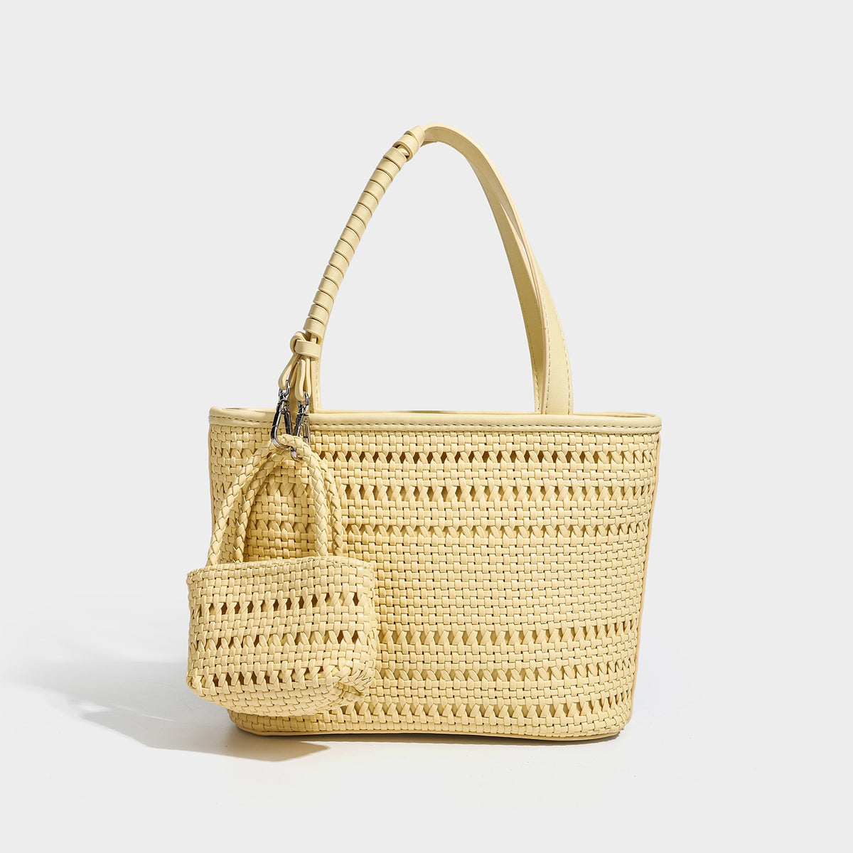 Structured open-weave tote bag with smooth leather-look trim, double top handles, detachable crossbody strap, and mini zip