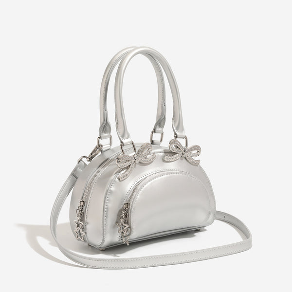 Structured half-moon mini handbag with silver-tone crystal bow hardware and star charm chain, detail view 2