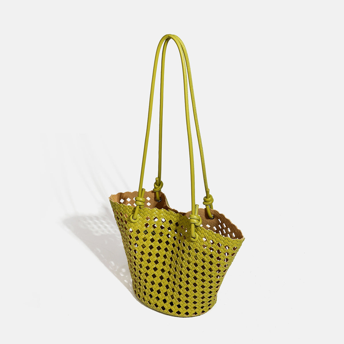 Open-weave lattice bucket tote bag with long knotted cord handles and tapered silhouette, detail view 3