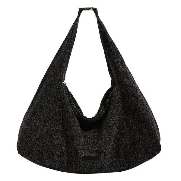 Oversized slouchy hobo shoulder bag in dark marled denim-texture fabric with top zip closure and adjustable single strap