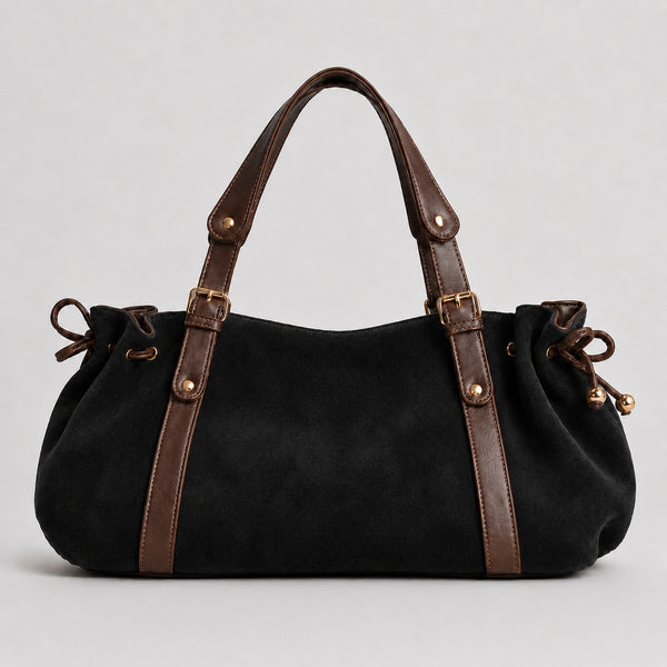 Soft suede-texture shoulder bag in brown with drawstring sides, leather-look vertical straps, gold-tone buckle hardware, and
