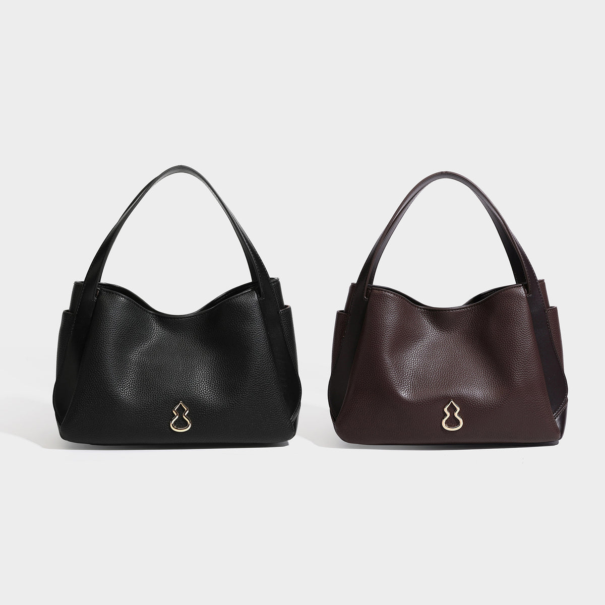 Black pebbled leather-look tote bag with gold-tone gourd hardware, dual top handles, and detachable crossbody strap, detail
