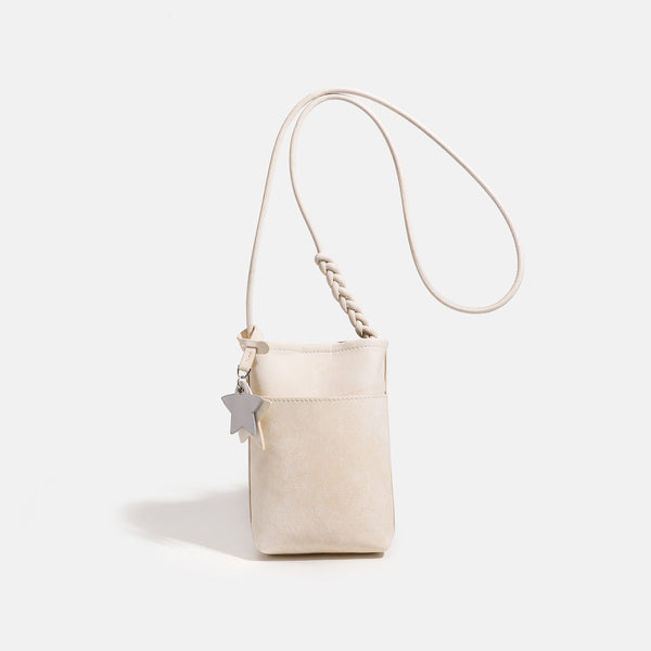 Small vertical textured mini crossbody phone bag with long braided cord strap and silver-toned star charm, detail view 7
