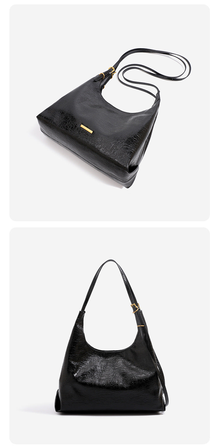 Slouchy hobo shoulder bag in crinkle high-gloss leather-look finish with gold-tone bar hardware and adjustable strap, detail