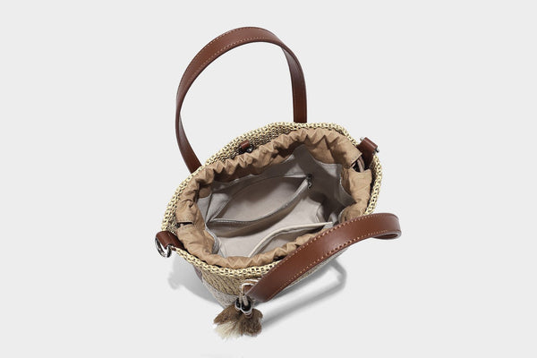 Two-tone open-weave tote bag in beige and cream with brown leather-look handles, tassel bead charm, and detachable
