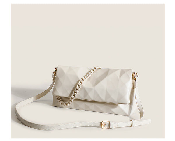 Cream white rectangular flap shoulder bag with geometric faceted surface and chunky tone-on-tone chain strap with gold-tone