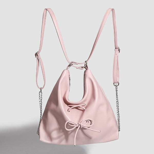 Glossy leather-look hobo shoulder bag with front bow lacing detail and silver-tone chain strap, detail view 2