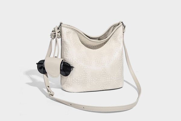 Diamond-quilted leather-look bucket shoulder bag with knotted strap accent and attached mini pouch, detail view 30