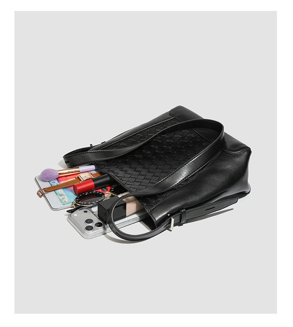 Large black bucket shoulder bag with diamond woven leather-look front panel, smooth side panels, magnetic snap closure, and