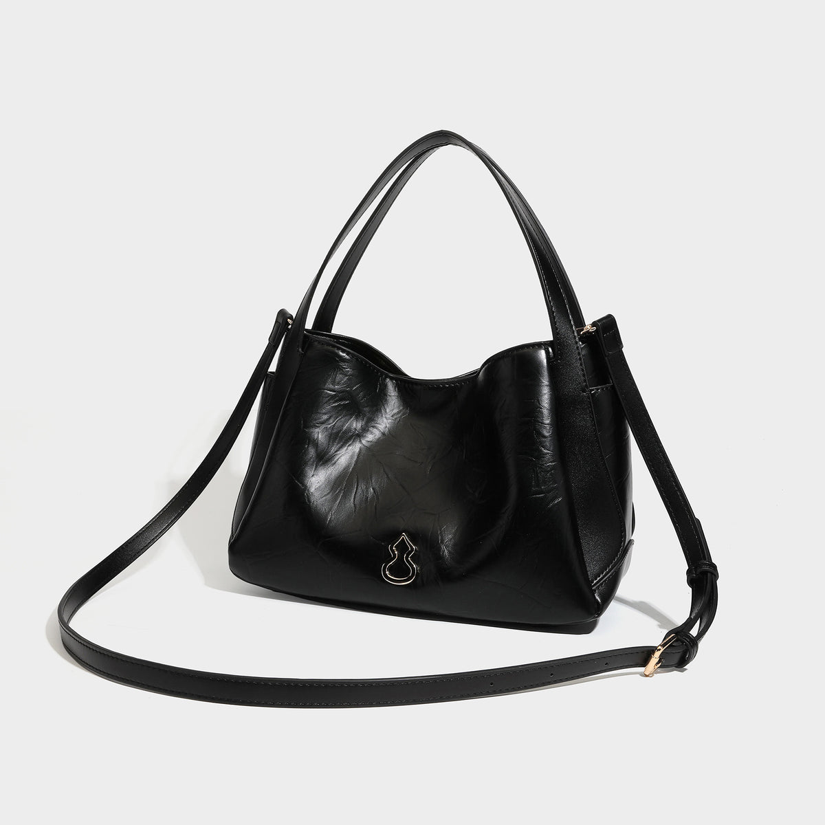 Black glossy crinkled leather-look convertible shoulder tote bag with gold gourd-shaped emblem hardware and detachable
