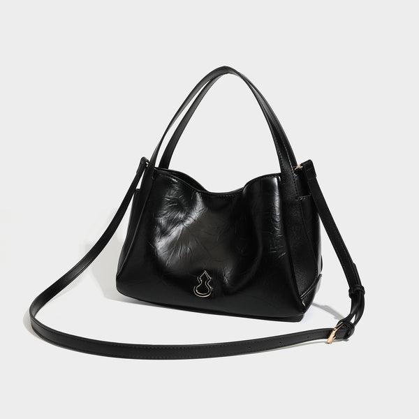 Black glossy crinkled leather-look convertible shoulder tote bag with gold gourd-shaped emblem hardware and detachable