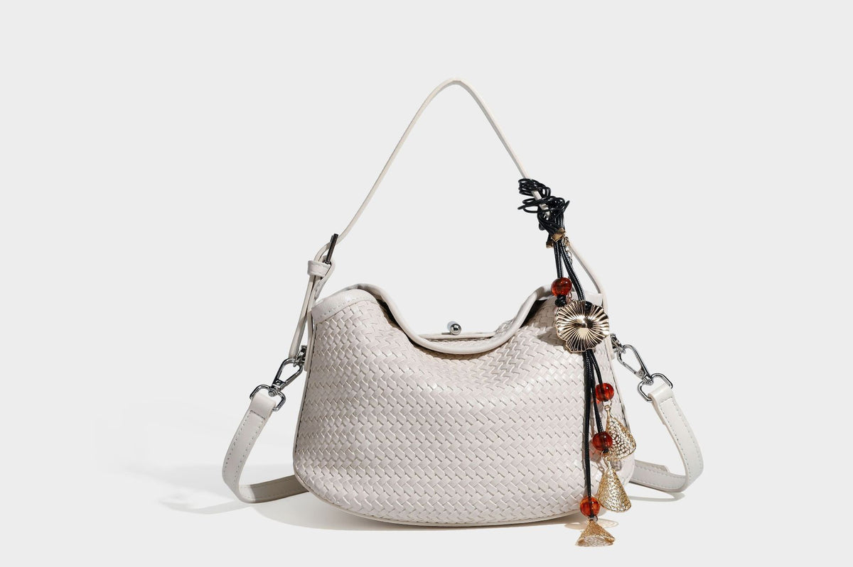 Small woven-look leather-look flap shoulder hobo bag in burgundy with silver-tone hardware and decorative tassel charm