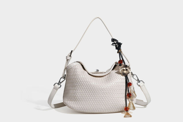 Small woven-look leather-look flap shoulder hobo bag in burgundy with silver-tone hardware and decorative tassel charm