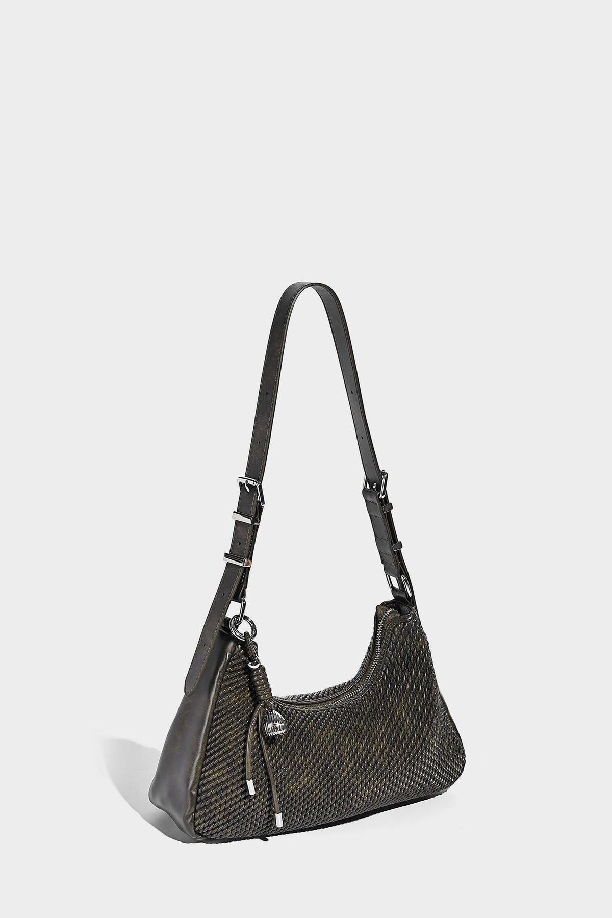 Woven crescent hobo shoulder bag with smooth side panels, zip-top closure, silver-tone charm hardware, and adjustable, detail