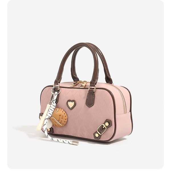 Small structured blush pink quilted diamond Boston barrel bag with brown leather-look trim, double top handles, heart accent