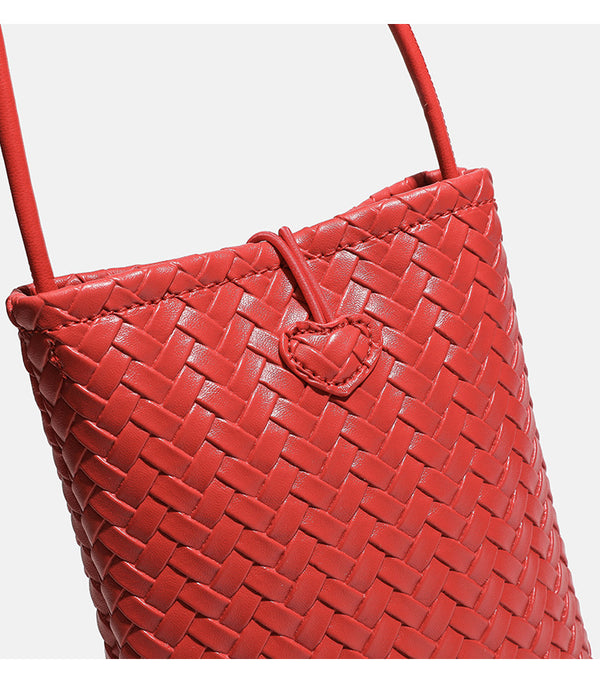 Compact woven leather-look bucket crossbody pouch with toggle closure and long fixed strap, detail view 15