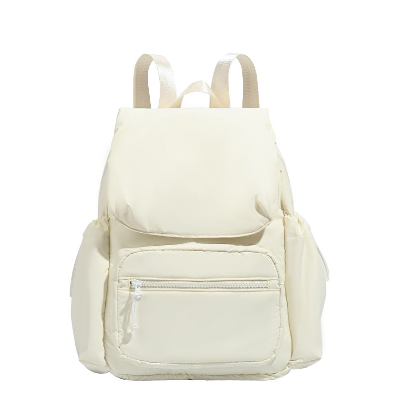 Soft matte nylon flap backpack with front zip pocket and side drawcord pockets, detail view 5
