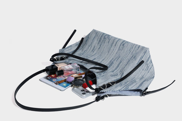 Large slouchy woven-texture shoulder tote bag with slim leather-look straps, side cinch ties, and silver-tone hardware