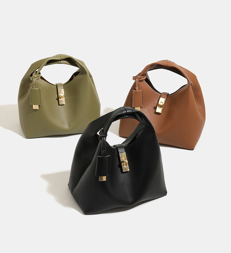 Structured pebbled leather-look bucket bag with gold-tone turn-lock clasp and looped top handle, detail view 11
