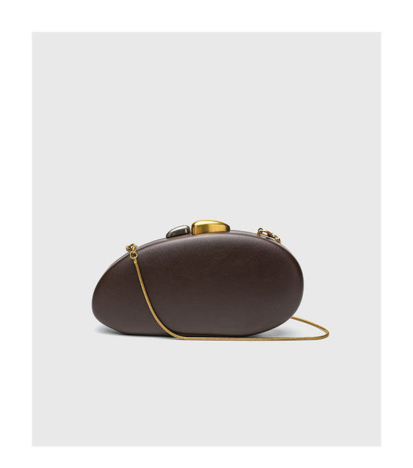 Oval hard-shell crossbody clutch bag with smooth matte leather-look finish and gold-tone snake chain strap, detail view 11