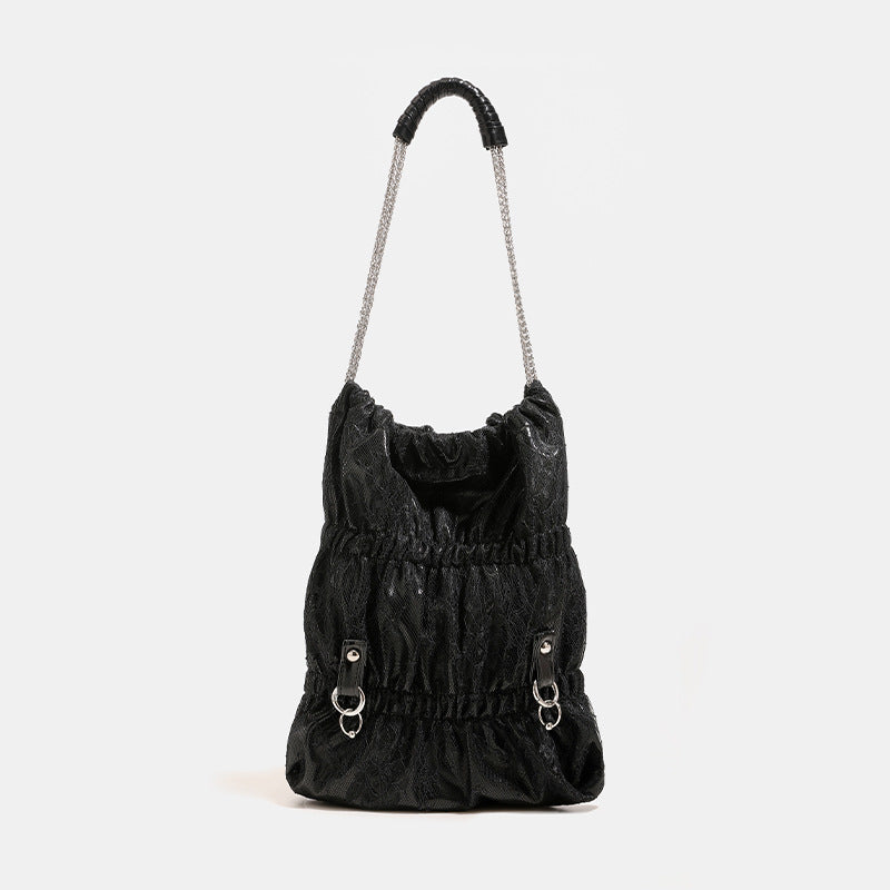 Slouchy lace-texture bucket bag with silver-tone chain strap, draped chain hardware, and shell charms, detail view 7