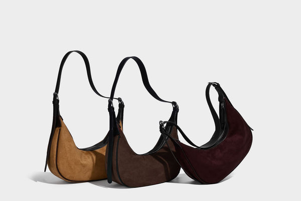 Crescent hobo shoulder bag in matte suede-look finish with black trim and adjustable strap, detail view 16