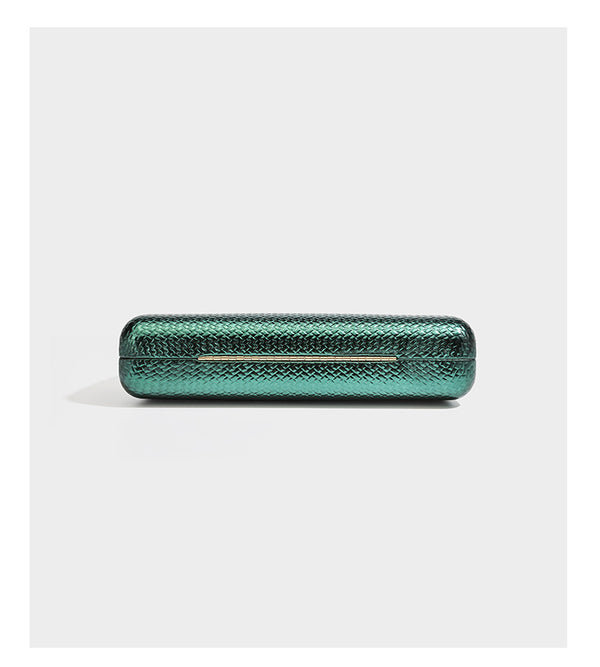 Structured rectangular metallic woven clutch bag with sculptural gold-tone leaf top handle and detachable chain strap, detail