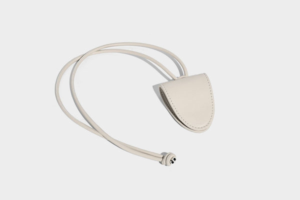 Diamond-quilted leather-look bucket shoulder bag with knotted strap accent and attached mini pouch, detail view 15