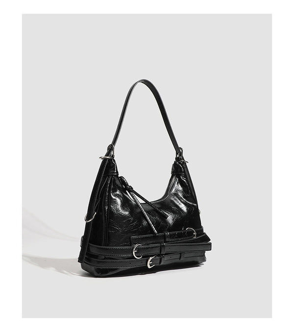 Slouchy hobo shoulder bag in glossy crinkled leather-look finish with silver-tone buckle hardware and slim adjustable strap