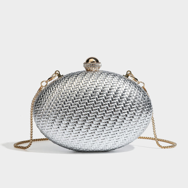 Kleine ovale Clutch aus metallisch glänzendem Flechtmaterial mit schmucksteinbesetztem goldfarbenem Bügelverschluss und abnehmbarem Kettenriemen, Detailansicht 4