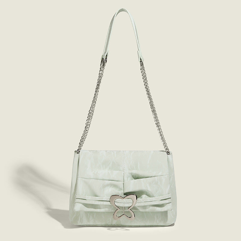 Structured rectangular chain shoulder bag with silver butterfly clasp and glossy crinkled finish, front view