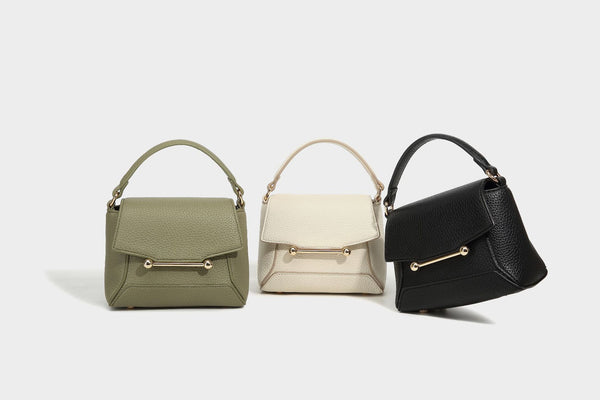 Small structured pebbled flap mini satchel with gold-tone bar hardware, short top handle, and detachable crossbody strap