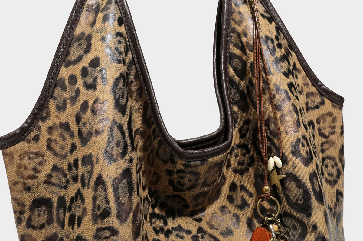 Large slouchy leopard-print shoulder tote bag with glossy tan-and-brown finish, dark brown leather-look trim, single