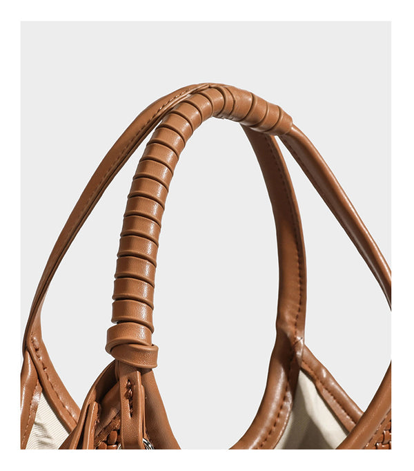 Color-block woven tote bag with rounded leather-look handles, detachable crossbody strap, and matching mini clip-on pouch in