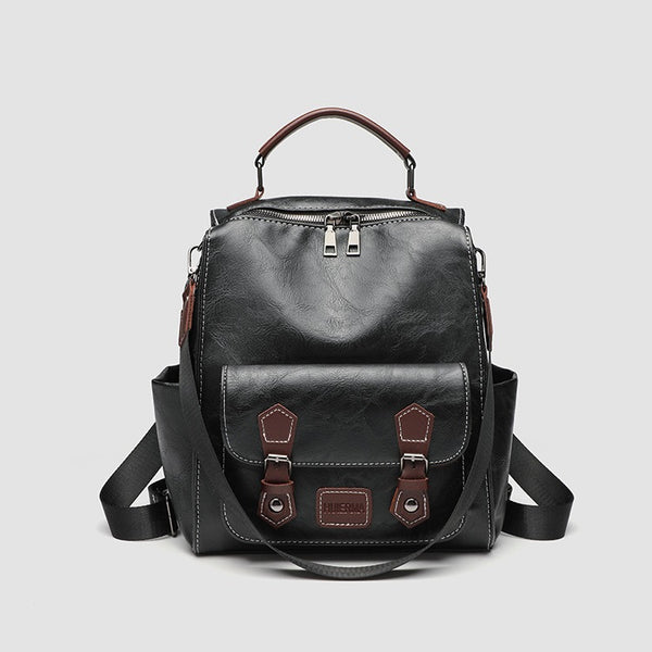 Structured black leather-look convertible backpack handbag with brown contrast trim, buckle front pocket, double-zip top