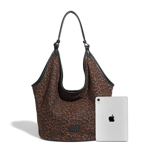 Slouchy brown leopard jacquard hobo tote bag with black leather-look trim and single shoulder strap, shown with black, detail