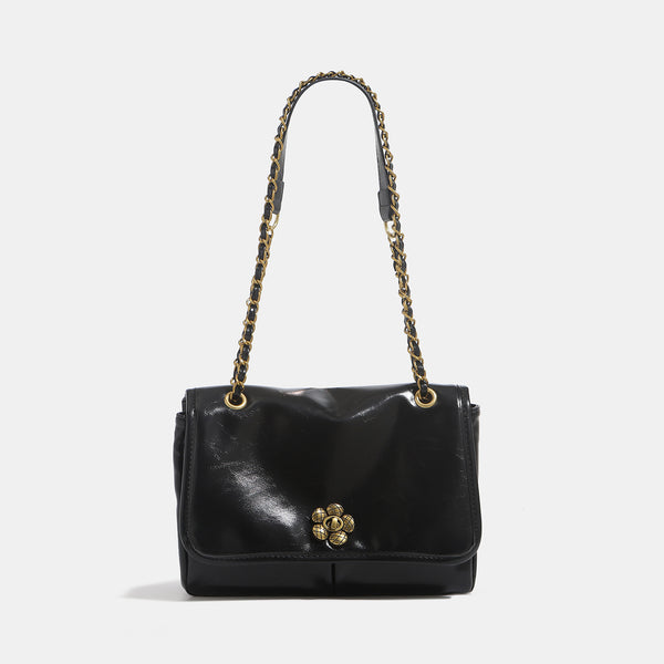 Structured glossy flap shoulder bag with antique gold floral turn-lock clasp and chain-and-leather strap, detail view 7