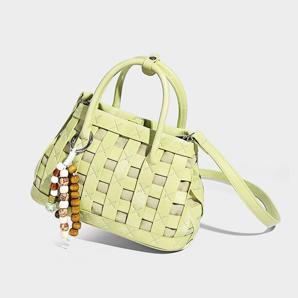 Small structured woven satchel tote with rounded top handles, silver-tone ring hardware, and bead tassel charm, detail view 8